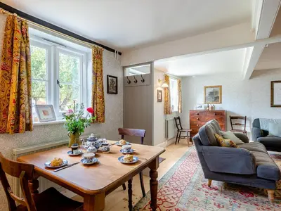 a living room with a table and a couch at Little Crown in Winfarthing