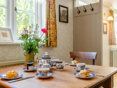 a wooden table with plates of food on it at Little Crown in Winfarthing