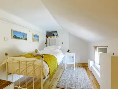 a bedroom with a bed with a yellow blanket at Angel Lane in Woodbridge