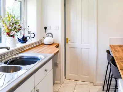a kitchen with a sink and a counter at The Bothy in Hockham