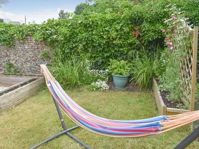a hammock laying on the grass in a garden at Beck Cottage in Mildenhall