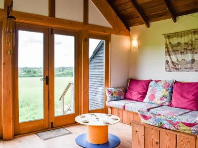 a living room with a couch and a table at The Long Barn in Chelmsford