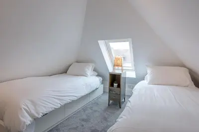 a bedroom with two beds and a window at The Art Room, Leiston in Leiston