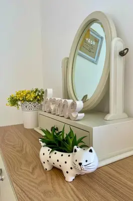 a bathroom with a dalmatian figurine next to a mirror at Stylish Boutique Bungalow in Felixstowe