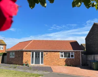 a brick house with a red roof at Stylish Boutique Bungalow in Felixstowe