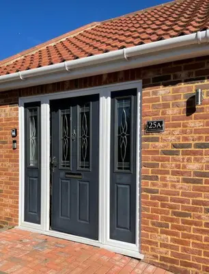 a brick house with black doors and a red roof at Stylish Boutique Bungalow in Felixstowe