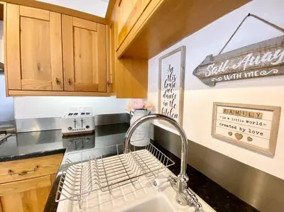 a kitchen with a sink with a faucet at Coastal Mews House close to Beach in Felixstowe