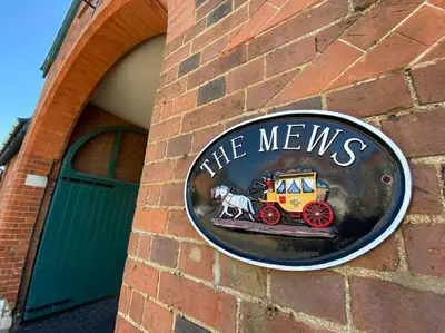 a sign on the side of a brick building at Coastal Mews House close to Beach in Felixstowe