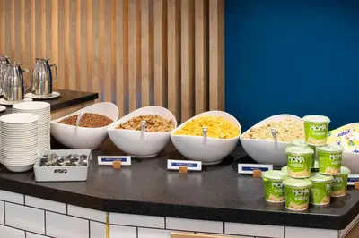 a group of bowls of food sitting on a counter at Holiday Inn Express Cambridge West - Cambourne by IHG in Cambridge