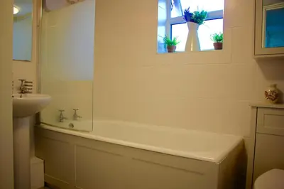 a bathroom with a bath tub and a sink at Romantic* Castle on the Hill Cottage *Framlingham in Framlingham