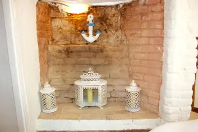 a room with two white tables and a wall at Romantic* Castle on the Hill Cottage *Framlingham in Framlingham