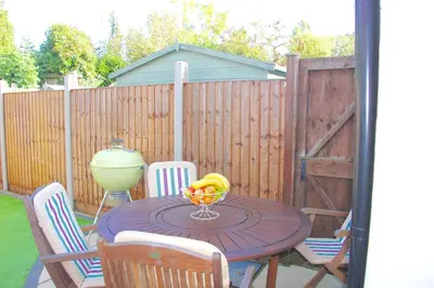 a table with a bowl of fruit on a patio at Romantic* Castle on the Hill Cottage *Framlingham in Framlingham