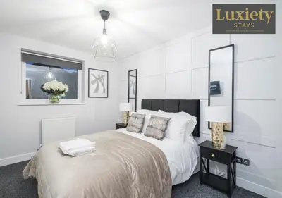 a white bedroom with a bed and two lamps at Stylish 1BR By Luxiety Stays Short Lets & Serviced Accommodation Southend on sea - Near High St & Southend Beach in Southend-on-Sea