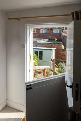 a window with a view of a brick building at Poppy Cottage, Aldeburgh - Prime location, close to the beach and High Street - Aldeburgh Coastal Cottages in Aldeburgh