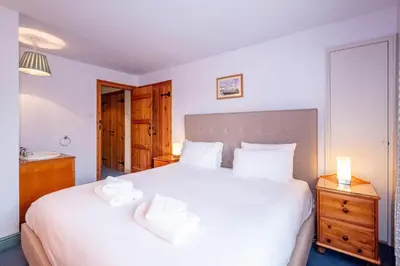 a bedroom with a large bed with two white pillows at Micawbers - Aldeburgh Coastal Cottages in Thorpeness