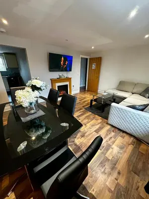 a living room with a table and a couch at Two Bedroom Flat Town Centre Colchester in Colchester