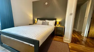 a bedroom with a large bed with two night stands at Two Bedroom Flat Town Centre Colchester in Colchester