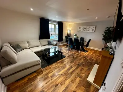 a living room with a couch and a table at Two Bedroom Flat Town Centre Colchester in Colchester