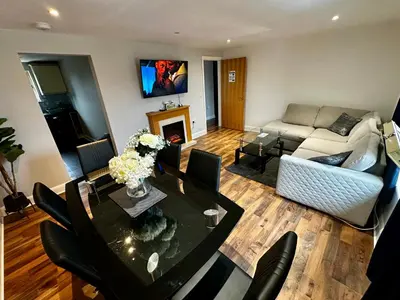 a living room with a table and a couch at Two Bedroom Flat Town Centre Colchester in Colchester