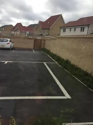 a car parked in a parking lot next to a brick wall at Beautiful Double Bedroom- In a modern 2 bed shared house in Chigwell