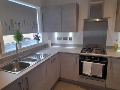 a kitchen with a sink and a stove top oven at Beautiful Double Bedroom- In a modern 2 bed shared house in Chigwell