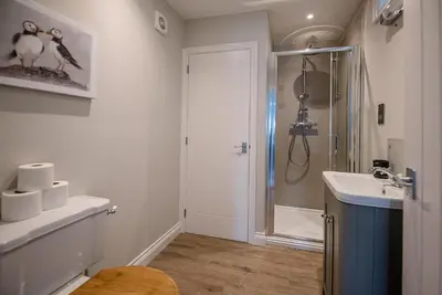 a bathroom with a shower and a sink at Pebble View, Aldeburgh in Aldeburgh