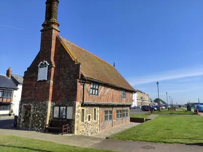 an old brick building with a chimney on a street at 4 Market Cross House, Aldeburgh in Aldeburgh