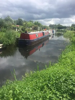 a boat is docked on a river at Private Detached Annex in Isleham Village in Isleham