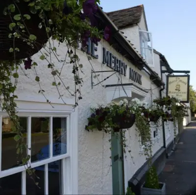 a white building with flowers on the side of it at Private Detached Annex in Isleham Village in Isleham