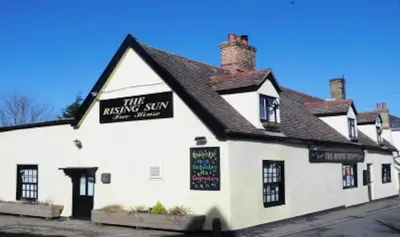 a white building with a black sign on it at Private Detached Annex in Isleham Village in Isleham
