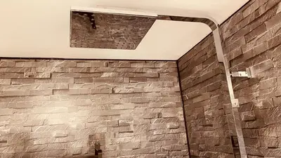 a stone wall in a bathroom with a ceiling at Private Detached Annex in Isleham Village in Isleham