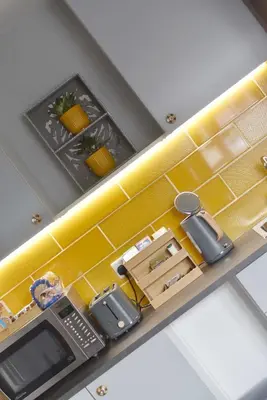 an overhead view of a kitchen with yellow tiles at Modern Luxury 1 bed apartment with parking near Stansted Airport in Stansted Mountfitchet