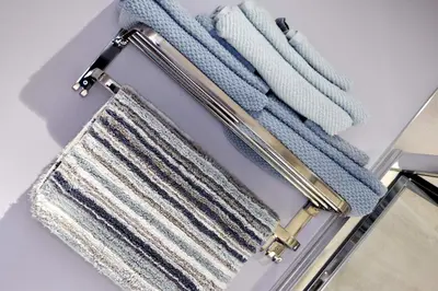 a towel rack with three towels on it at Modern Luxury 1 bed apartment with parking near Stansted Airport in Stansted Mountfitchet