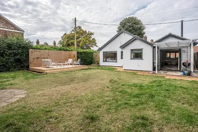 a backyard of a house with a patio at Festival House, Snape in Saxmundham