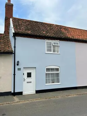 a white house with two windows and a door at North Cottage, Alderton in Woodbridge