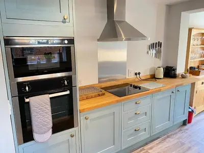 a kitchen with a sink and a stove top oven at Refurbished Victorian Villa- Free Parking- Sleeps6 in Bury Saint Edmunds