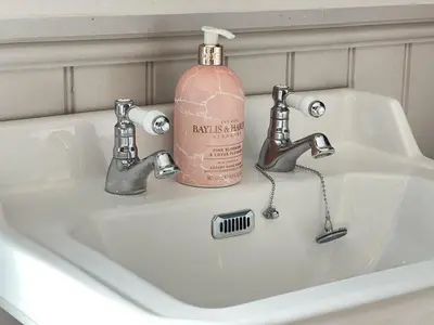 a bathroom sink with a pink soap bottle on it at Refurbished Victorian Villa- Free Parking- Sleeps6 in Bury Saint Edmunds
