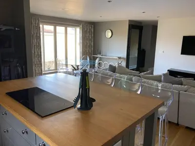 a kitchen and living room with a table and a couch at The Oaks, Luxury 2 bedroom cottage in a peaceful location in Haughley