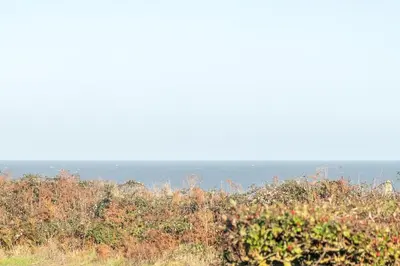 a view of the ocean from the top of a hill at Chelsea Lodge - Aldeburgh Coastal Cottages in Sizewell