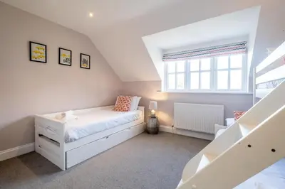 a bedroom with a bed and a window at 1 Sanctuary Court - Aldeburgh Coastal Cottages in Thorpeness