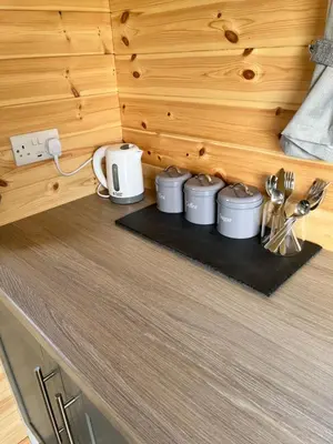 a kitchen counter with four crock pots and utensils at Wildflower Meadow Cabins in Whitington