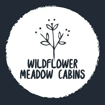 a white label with a tree and the words wildflower meadowcalls at Wildflower Meadow Cabins in Whitington