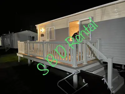 a house with a sign that says house at Summer Breeze Deluxe Caravan Rental in Saint Osyth