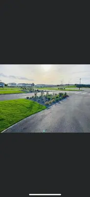 an empty road with flowers on the side of the road at Summer Breeze Deluxe Caravan Rental in Saint Osyth