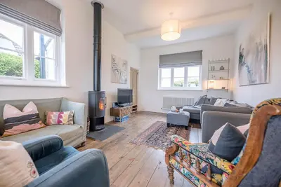 a living room with a couch and a fire place at The Artist's House, Orford in Orford