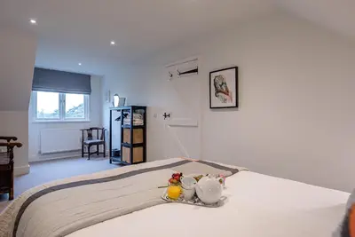 a bedroom with a bed with two rubber ducks on it at The Artist's House, Orford in Orford