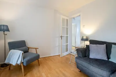a living room with two chairs and a couch at The Britten - Aldeburgh Coastal Cottages in Aldeburgh