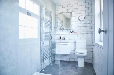 a white bathroom with a toilet and a sink at SEALOFT, Aldeburgh , Stay in Suffolk in Aldeburgh