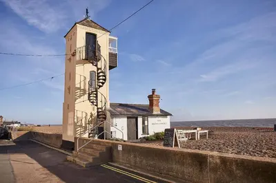 a building on the beach with the ocean behind it at SEALOFT, Aldeburgh , Stay in Suffolk in Aldeburgh