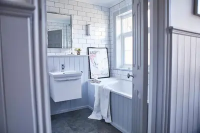 a bathroom with a sink and a bath tub and a mirror at SEALOFT, Aldeburgh , Stay in Suffolk in Aldeburgh
